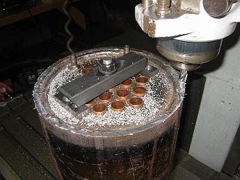  Using a large piece of all-thread rod, and bridging the soft copper flues, the boiler is lightly held down to skim the top surface smooth.
